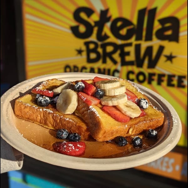 Stella Blue Bistro's French toast topped with fresh strawberries, blueberries, bananas, and powdered sugar.